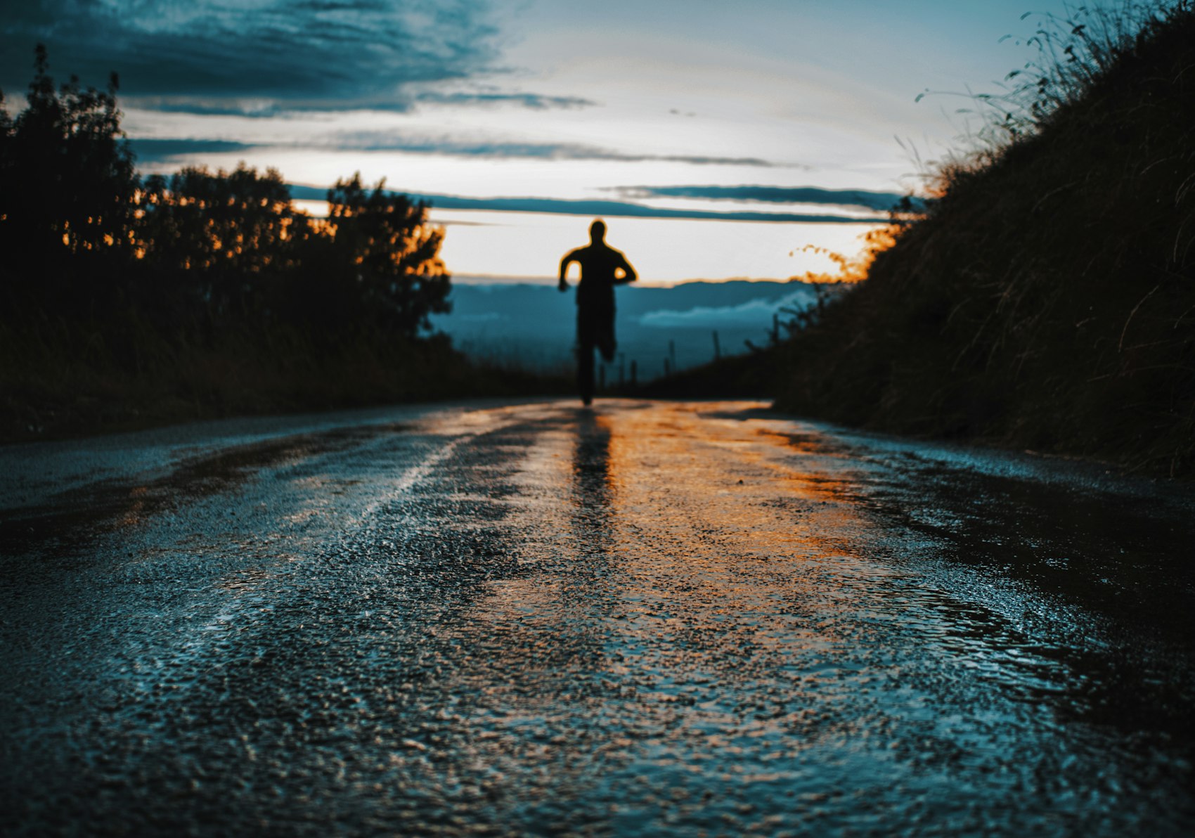 A runner at dawn on an open road